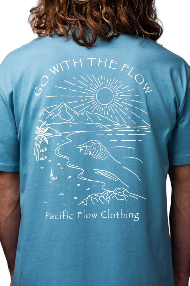 a view of the mountains, the ocean, a surfer and the shipwreck from Byron Bay on a ocean blue shirt