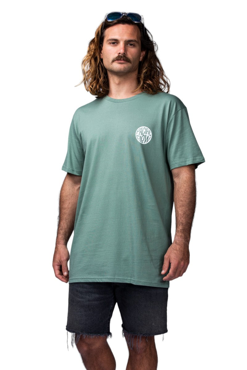 A green shirt with the mountains a river, the sun, and evergreen trees.