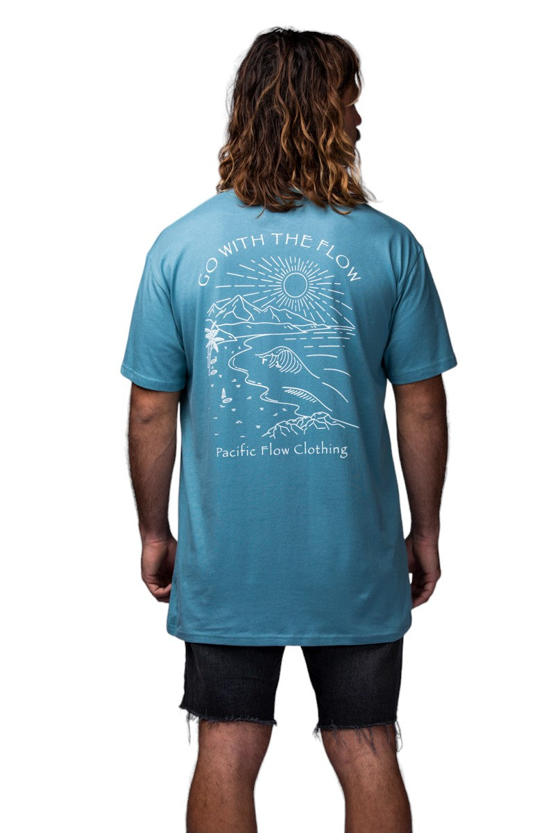 a view of the mountains, the ocean, a surfer and the shipwreck from Byron Bay on a ocean blue shirt