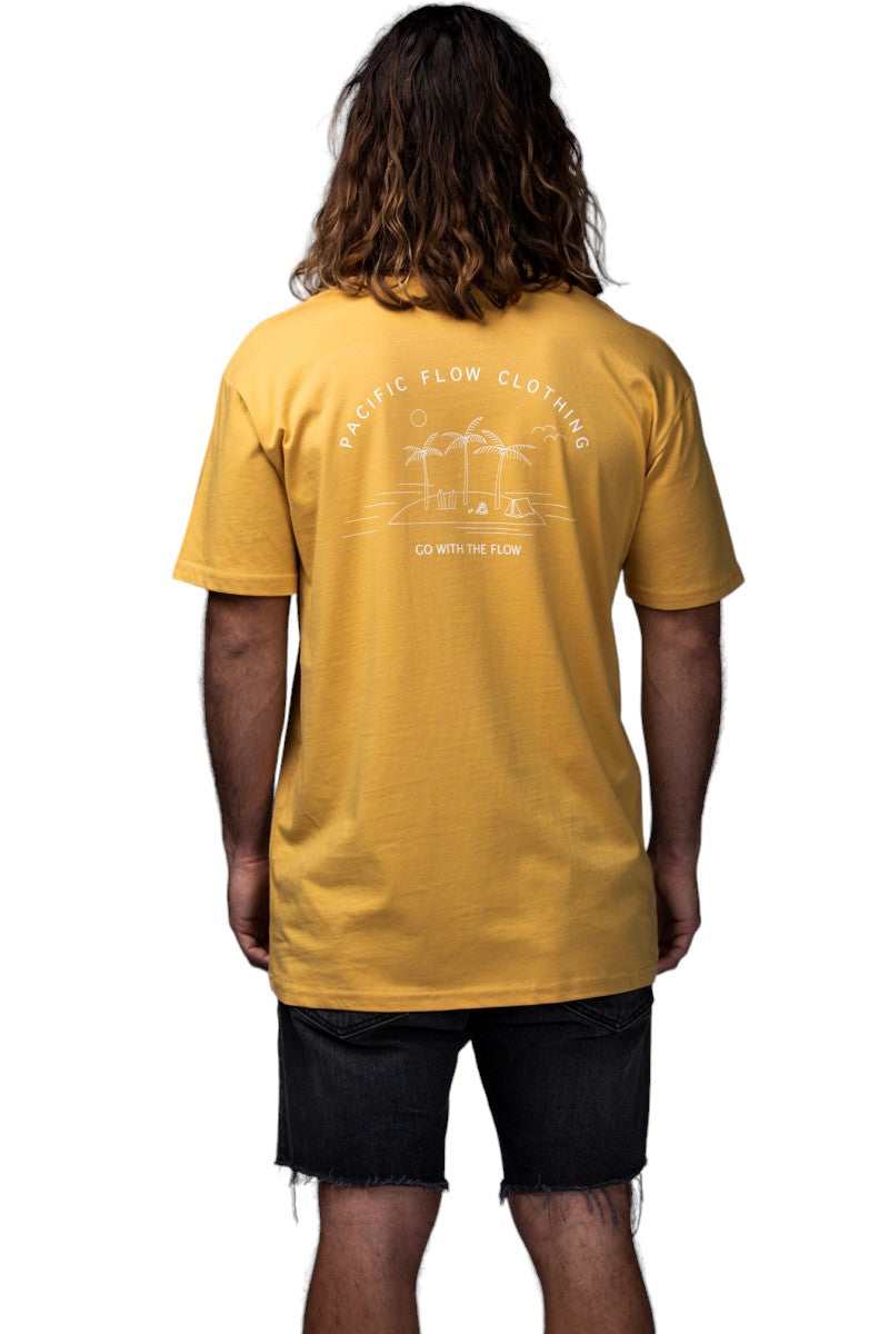A mustard coloured shirt with an island on the back, with surfboards, a fire, palmtrees, a tent, and waves to surf.