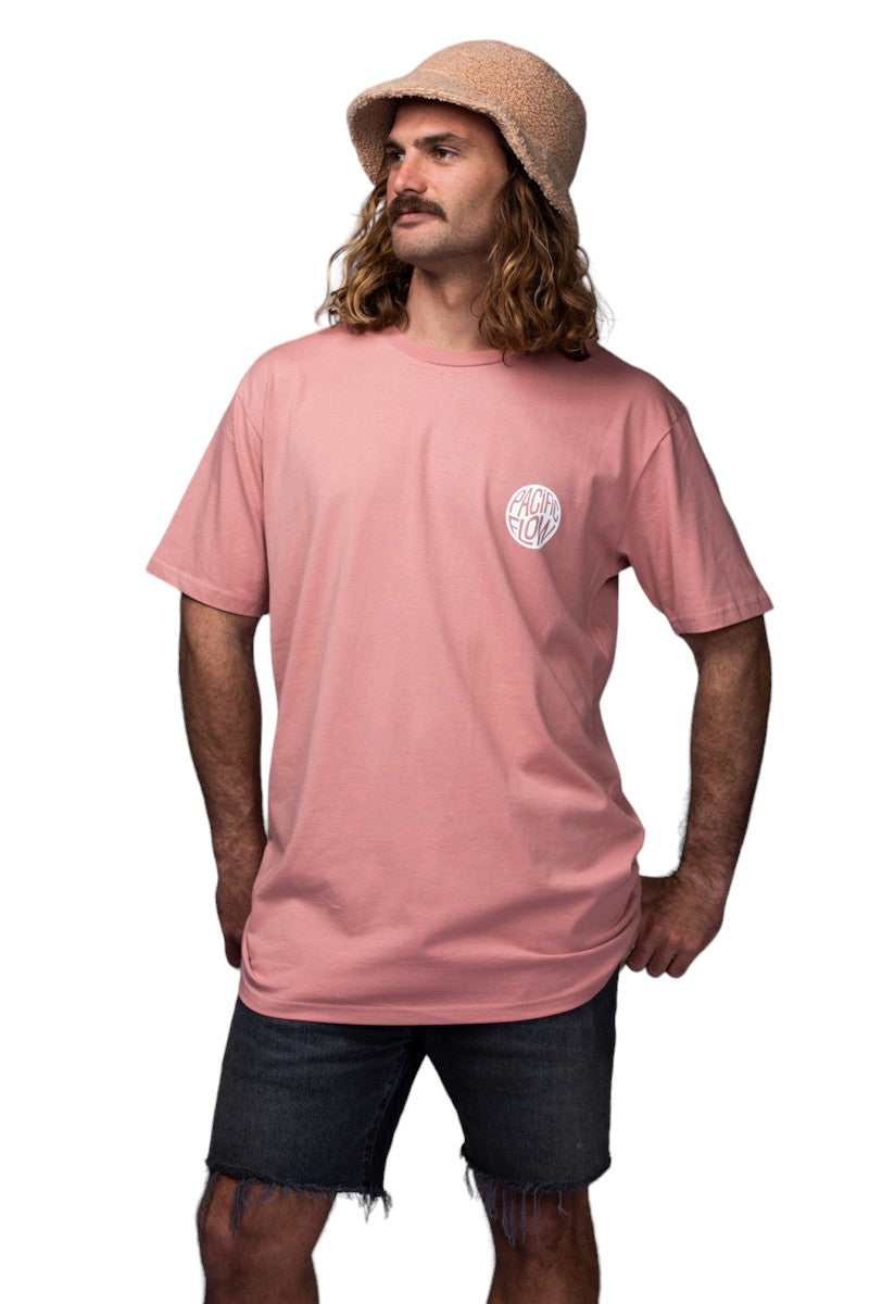 A rose coloured shirt with an island on the back, with surfboards, a fire, palmtrees, a tent, and waves to surf.