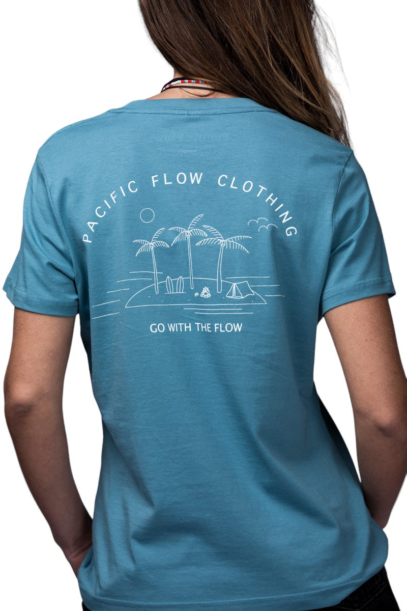 An ocean blue coloured shirt with an island on the back, with surfboards, a fire, palmtrees, a tent, and waves to surf.