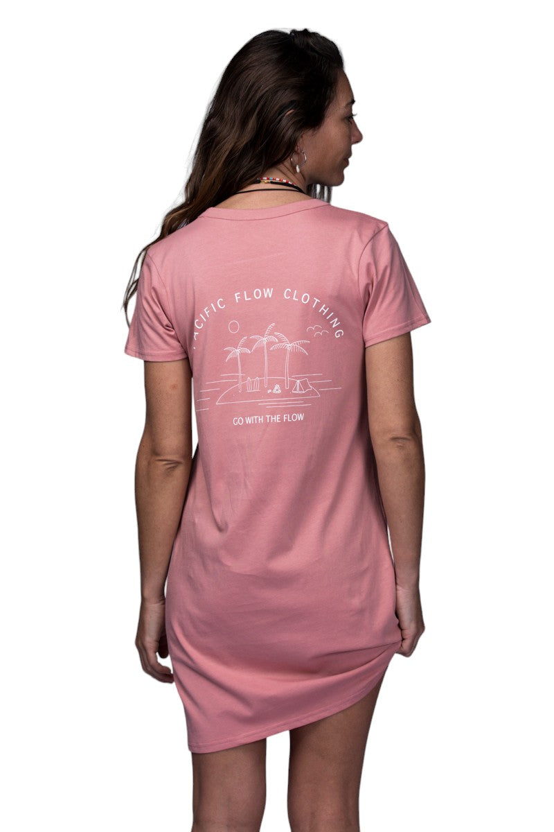 A rose coloured dress with an island on the back, with surfboards, a fire, palmtrees, a tent, and waves to surf.